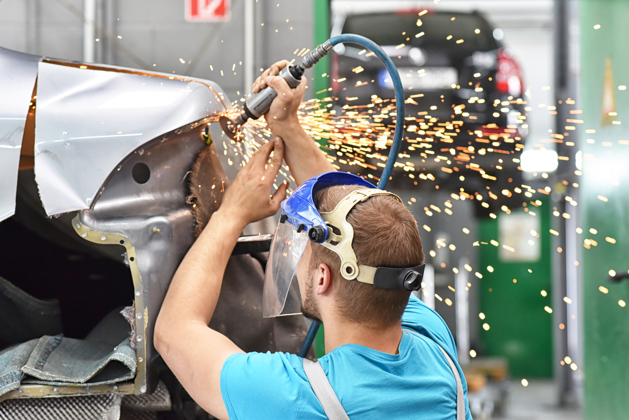 Repair Car Body By A Mechanics In The Workshop