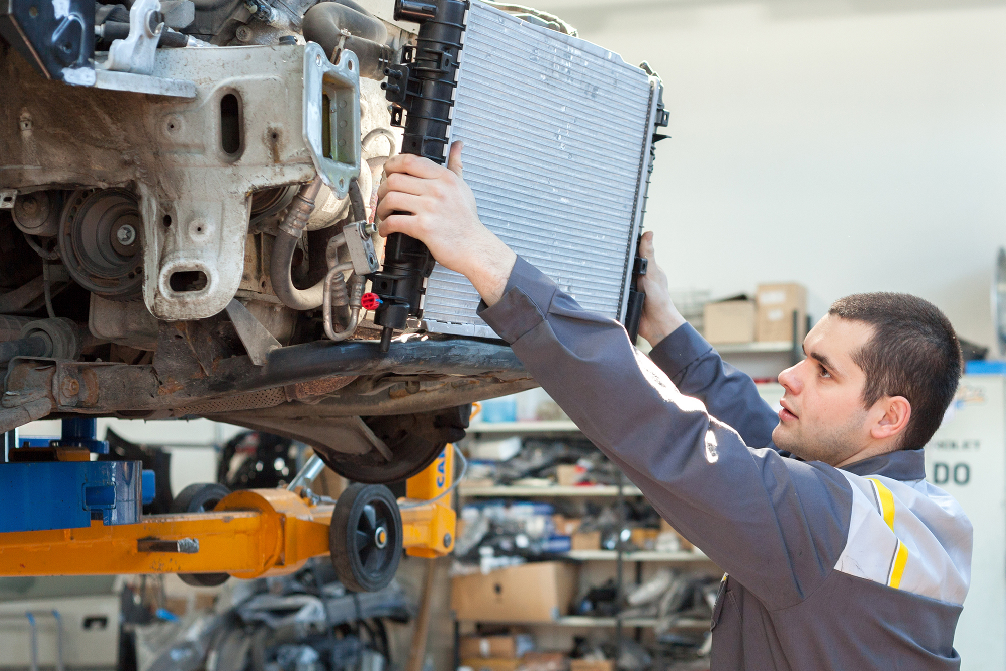 Car Mechanic Changing The Radiator